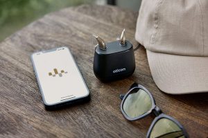 Oticon_Intent_Still_Life_miniRITE_Charger_iPhone_Sunglasses